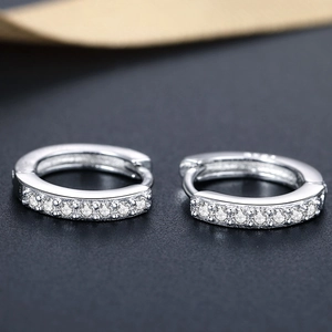 Macro shot of S925 sterling silver huggie earrings with micro-pave sparkling zircon stones