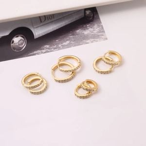 Detailed shot of gold hoop earrings with micro-set zircon and S925 hallmark