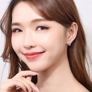 Minimalist S925 silver hoop earrings with sky blue crystal stones shown on model