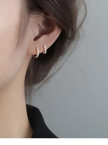 Close-up of gold-plated hoop earrings with sparkling micro-pave cubic zirconia stones