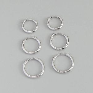 Close-up of three pairs of S925 sterling silver hoop earrings in different sizes