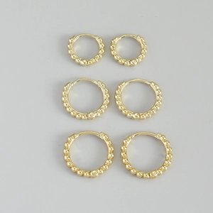 Three-piece set of gold beaded hoop earrings in varied sizes with a textured ball design