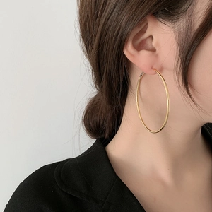 Elegant large gold hoop earrings for women featuring a minimalist polished circular design