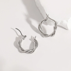 Detailed close-up showing the S925 hallmark on minimalist silver twisted hoop earrings