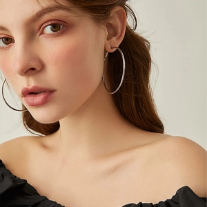 Detailed close-up of 3mm wide silver hoop earrings with a polished round surface
