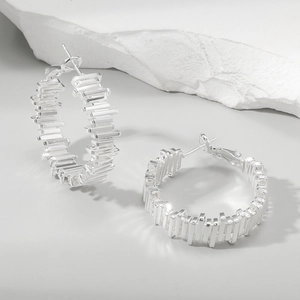 Close-up of irregular textured geometric hoop earrings made of s925 silver metal