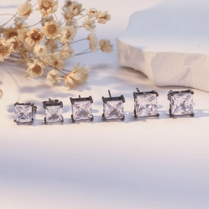 Set of six square-cut black metal stud earrings with white zircons in various sizes