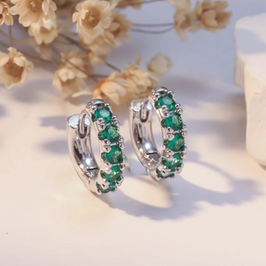 Polished silver hoops earrings with micro-pave emerald green cubic zirconia stones