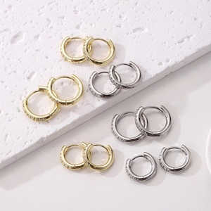 Detail of gold and silver S925 sterling silver hoop earrings with micro-pave cubic zirconia