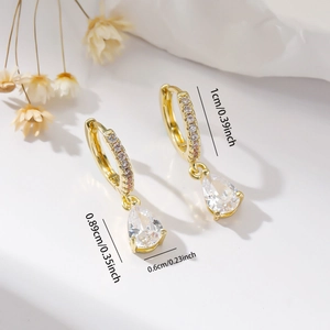 Detailed view of gold hoop earrings with pear-shaped cubic zirconia and size dimensions