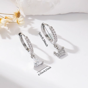 Detail shot of silver hoop earrings with zircon crown and triangle charms with dimensions