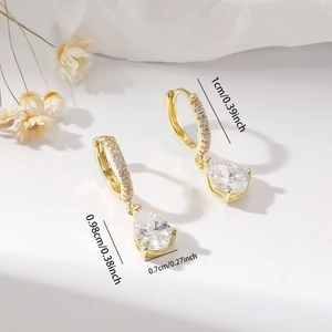 Close-up of gold pear-cut cubic zirconia drop earrings with measurement labels