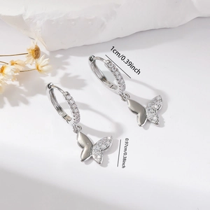 Detailed macro view of silver butterfly hoop earrings with dimensions 1cm and 0.97cm