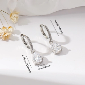 Detail view of silver hoop earrings with teardrop zircon pendant and size measurements