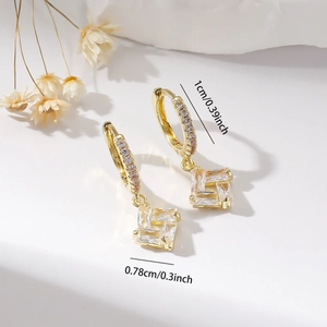 Macro view of gold-plated square zircon earrings with dimensions 1cm and 0.78cm