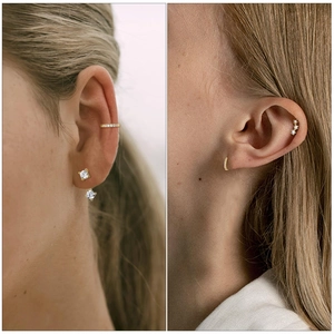 Detail of gold-plated stud earrings and ear cuffs set with cubic zirconia on a model