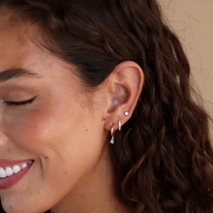 Close-up of model wearing gold-plated S925 silver needle earrings with zircon sets