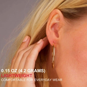 Close-up of lightweight gold hoop earrings worn by model for comfortable everyday wear