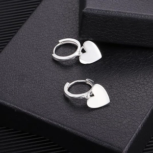 Elegant S925 sterling silver hoop earrings with polished heart-shaped pendants for women