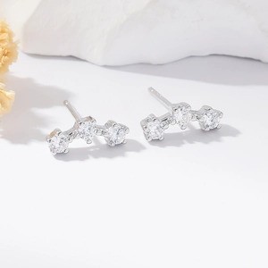 Macro detail of three circular cubic zirconia stones on S925 silver stud earrings