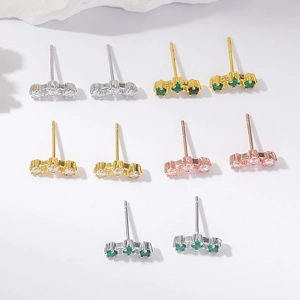 Three-stone curved stud earrings in silver, gold and rose gold with white and green stones