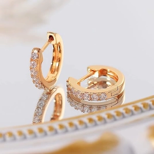 Elegant 14K gold plated hoop earrings with sparkling cubic zirconia on mirror background