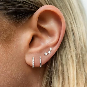 S925 silver hoop earrings set with zircon studs on model ear for a layered look
