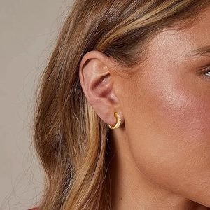 Close-up of 14K gold plated hoop earrings with micro-paved sparkling cubic zirconia