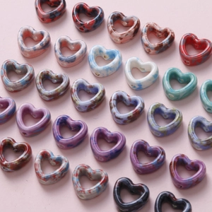 Macro detail of colorful marbled heart-shaped beads for DIY jewelry and crafts