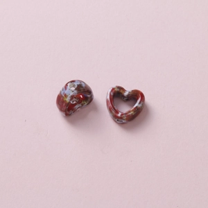 Detail of heart-shaped ceramic beads with multi-colored marble texture for DIY jewelry making