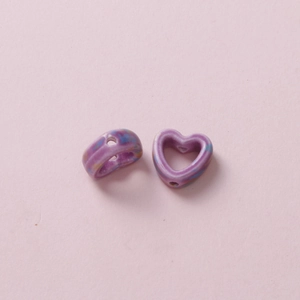 Detailed macro view of purple marble pattern heart-shaped ceramic beads for DIY jewelry making