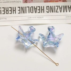 Macro detail of aurora acrylic crown charms with metallic pin for DIY hair accessories