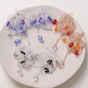 Detailed view of handmade beaded floral tassels and crystal charms for DIY jewelry making