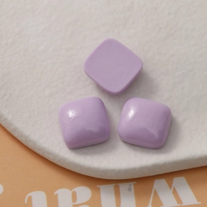 Close-up of three lavender purple square resin charms for DIY jewelry making