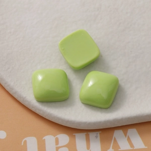 Close-up of 15mm light green macaron resin square beads for DIY jewelry and phone cases