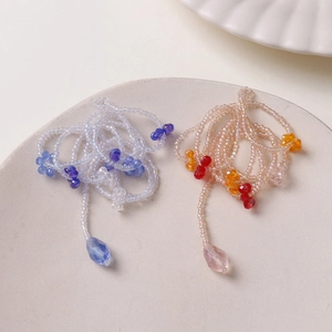 Handmade beaded floral tassel jewelry with blue and pink teardrop pendants for DIY accessories