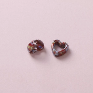 Macro shot of heart-shaped camouflage ceramic beads for DIY jewelry making