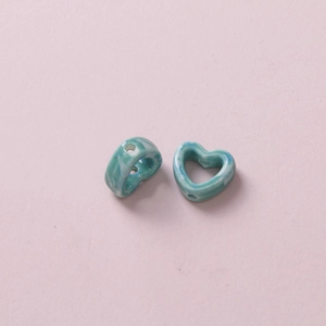 Detail of blue marble pattern heart ceramic beads with side holes for DIY jewelry