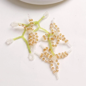 Macro detail of handmade crystal beaded flower twigs with clear and amber beads