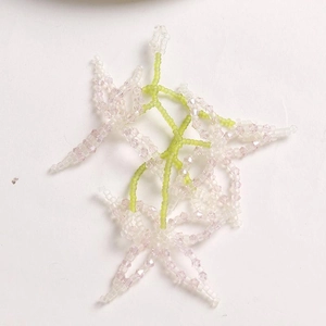Macro shot of handmade beaded flowers in pink and white for DIY jewelry making