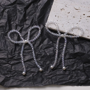 Exquisite crystal beaded bow hair accessories with white pearls on a stone background