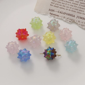Macro shot of colorful matte acrylic sea urchin beads with vertical holes for DIY jewelry