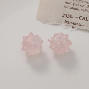 Close-up of matte pink aurora acrylic urchin beads for DIY jewelry making and crafts