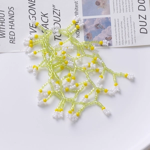 Handmade beaded tassel jewelry accessory with green, yellow, and white pearls in flower pattern