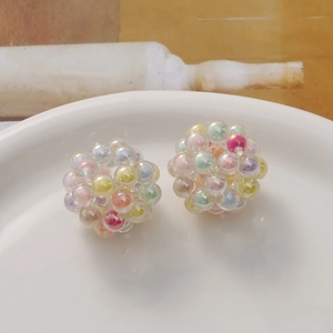 Close-up of handmade iridescent acrylic bead sphere charms for DIY jewelry making