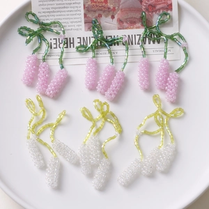 Close-up of handmade beaded lavender pendants in pink and white for jewelry DIY