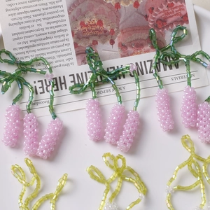 Macro shot of handmade beaded flower earrings featuring lavender and yellow seed bead details