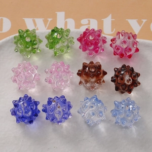 Colorful translucent spiky sea urchin beads for DIY jewelry making displayed on a plate