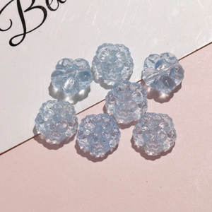 Macro view of translucent light blue 3D five-petal flower beads for DIY jewelry making