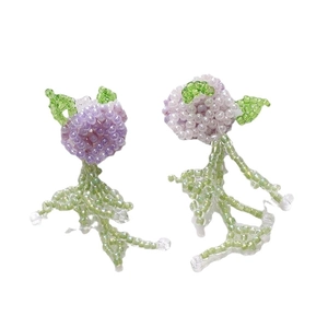 Handmade beaded wisteria flower earrings with purple petals and green leaf tassels